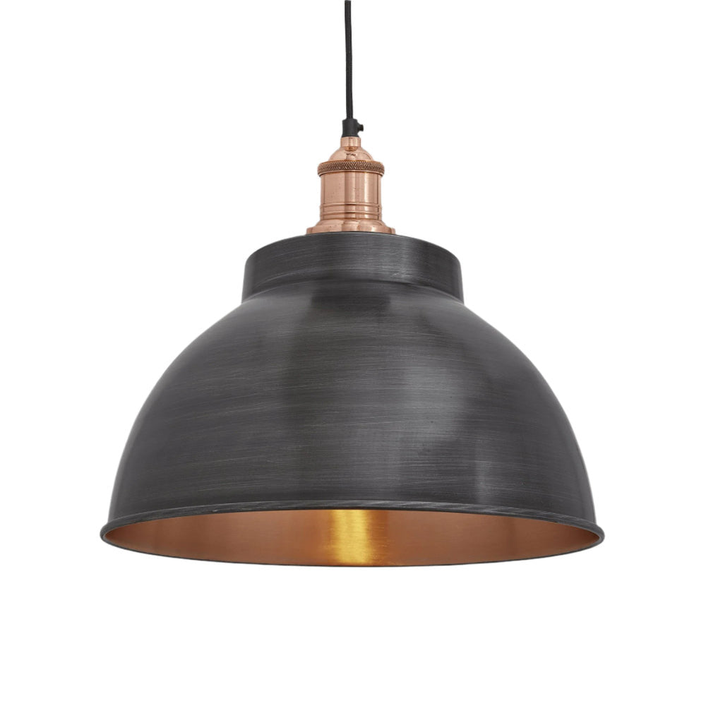 Industrial-style pendant light with a brushed pewter exterior and a warm copper interior, hanging from a black cord.