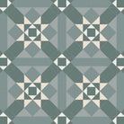 Victorian-style geometric tile pattern featuring interlocking squares and triangles in shades of green with warm white accents, forming repeating star motifs within a tessellated layout.   