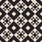 Victorian-style tile pattern with black star motifs on a cream background in a geometric grid.  