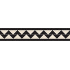 Double dogtooth tile border featuring black and white triangles framed in black for elegant interiors.