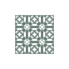 Geometric tile pattern with sage-green squares, white triangles, and diamond shapes arranged in a symmetrical, modern layout.  