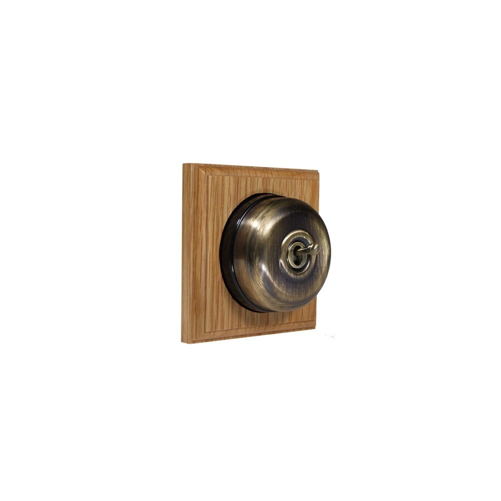 Switch to Wood's Dolly Light Switch Smooth Dome - 1 Gang Square Backplate Antique Brass in Light Oak