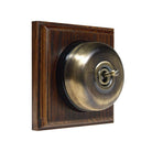 Switch to Wood's Dolly Light Switch Smooth Dome - 1 Gang Square Backplate Antique Brass in Dark Oak