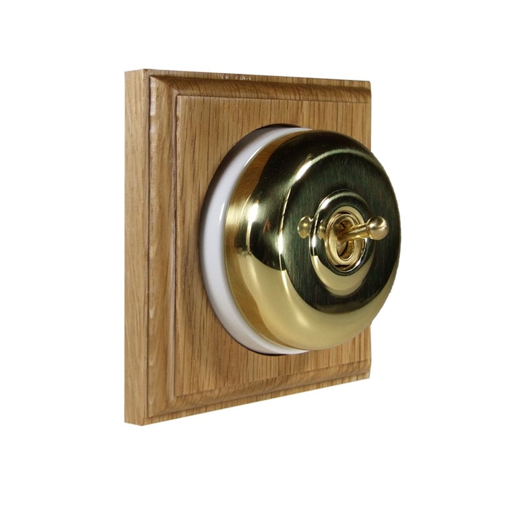 Switch to Wood's Dolly Light Switch Smooth Dome - 1 Gang Square Backplate Polished Brass in Light Oak