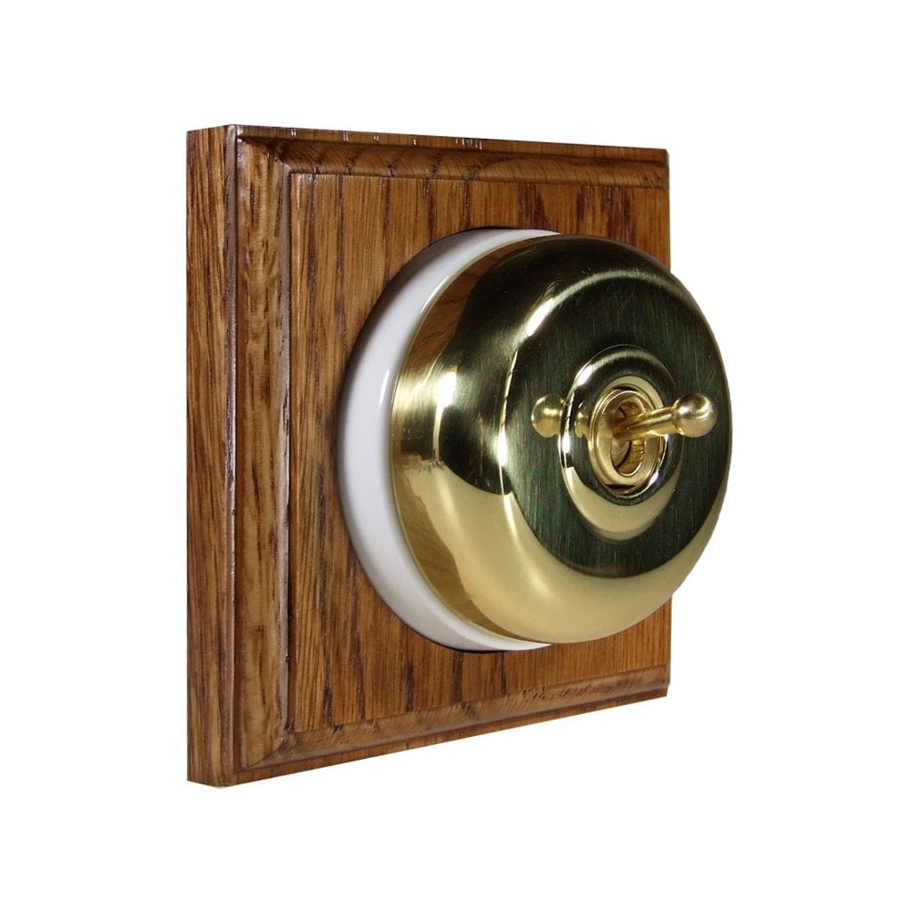 Switch to Wood's Dolly Light Switch Smooth Dome - 1 Gang Square Backplate Polished Brass in Medium Oak 