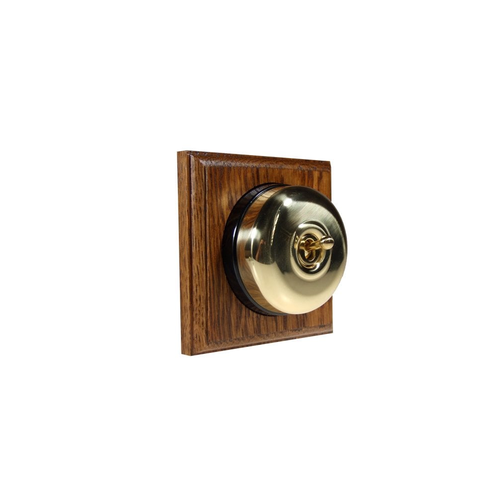 Switch to Wood's Dolly Light Switch Smooth Dome - 1 Gang Square Backplate Polished Brass in Medium Oak 