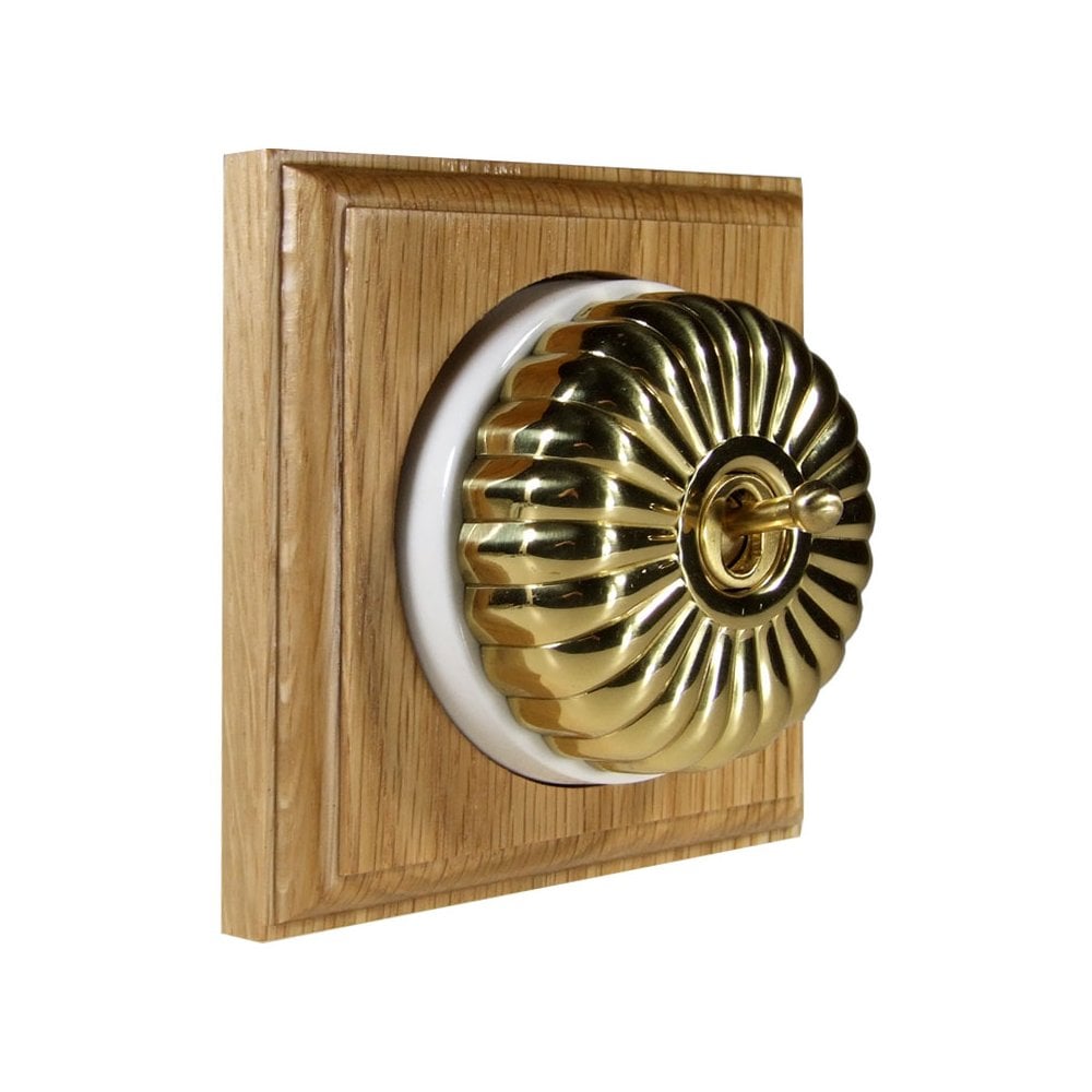 Switch to Wood's Dolly Light Switch Fluted Dome - 1 Gang Square Backplate Polished Brass in Light Oak