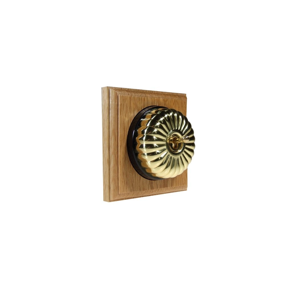 Switch to Wood's Dolly Light Switch Fluted Dome - 1 Gang Square Backplate Polished Brass in Light Oak