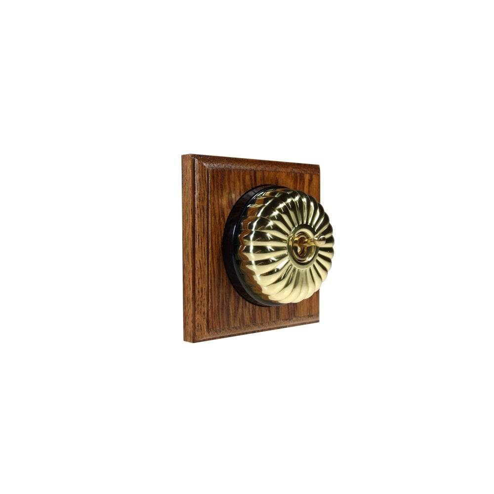 Switch to Wood's Dolly Light Switch Fluted Dome - 1 Gang Square Backplate Polished Brass in Medium Oak 