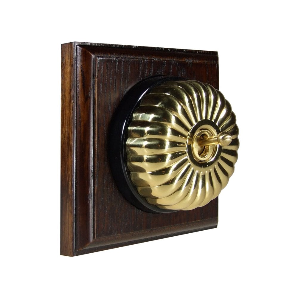 Switch to Wood's Dolly Light Switch Fluted Dome - 1 Gang Square Backplate Polished Brass in Dark Oak