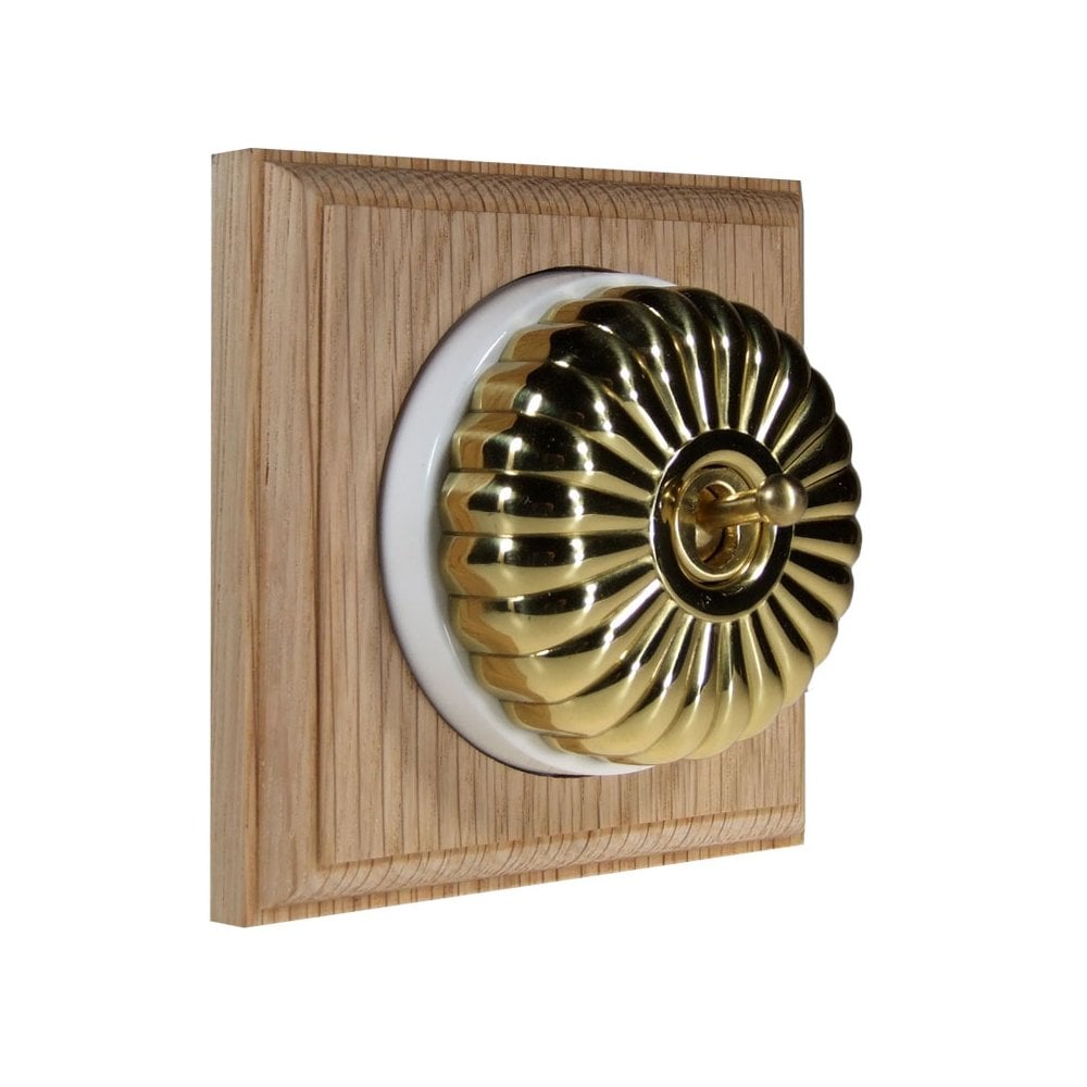Switch to Wood's Dolly Light Switch Fluted Dome - 1 Gang Square Backplate Polished Brass in Unfinished Oak
