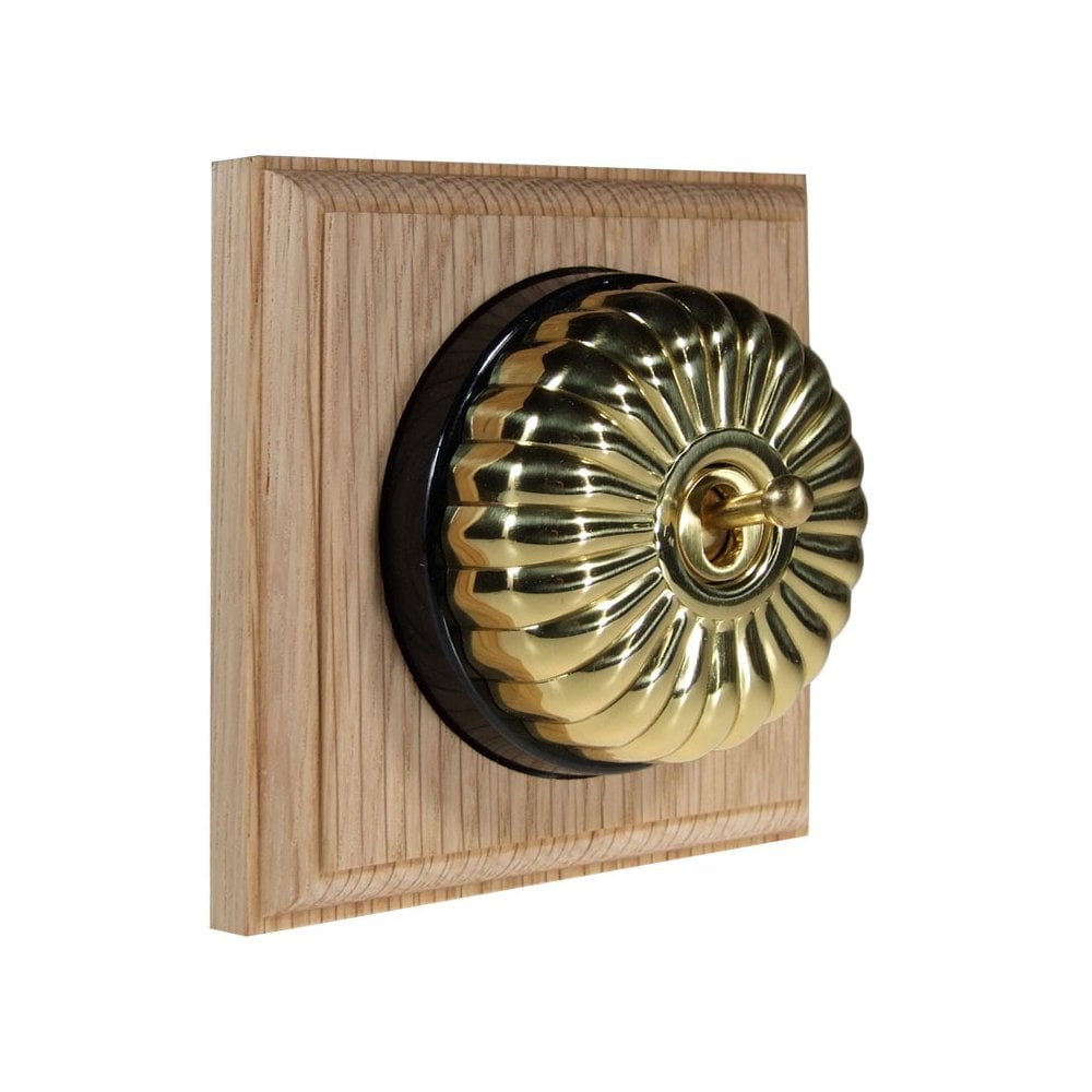 Switch to Wood's Dolly Light Switch Fluted Dome - 1 Gang Square Backplate Polished Brass in Unfinished Oak