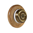 Switch to Wood's Dolly Light Switch Smooth Dome - 1 Gang Round Backplate Antique Brass in Light Oak