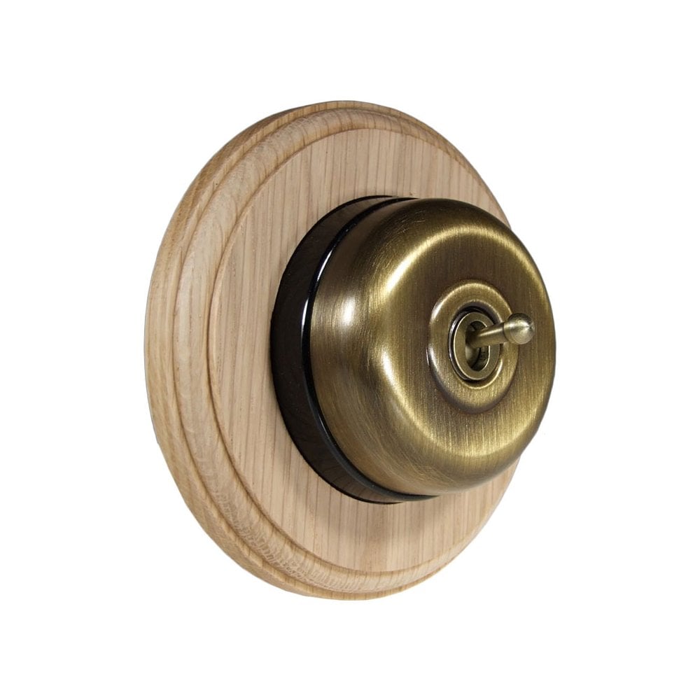 Switch to Wood's Dolly Light Switch Smooth Dome - 1 Gang Round Backplate Antique Brass in Unfinished Oak