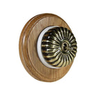 Switch to Wood's Dolly Light Switch Fluted Dome - 1 Gang Round Backplate Antique Brass in Light Oak