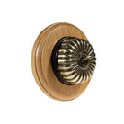 Switch to Wood's Dolly Light Switch Fluted Dome - 1 Gang Round Backplate Antique Brass in Light Oak