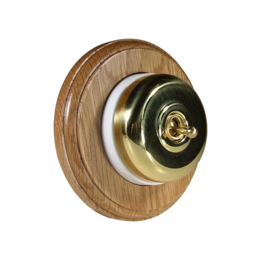 Switch to Wood's Dolly Light Switch Smooth Dome - 1 Gang Round Backplate Polished Brass in Light Oak