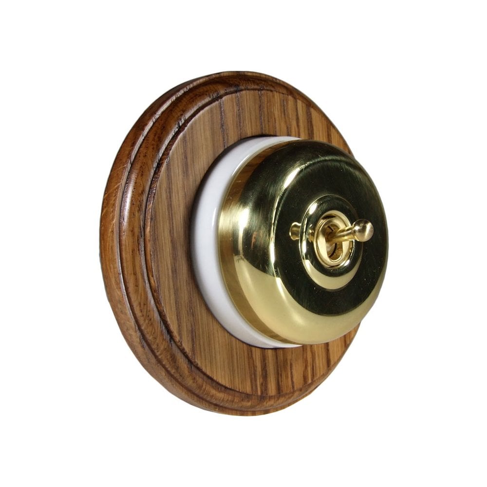 Switch to Wood's Dolly Light Switch Smooth Dome - 1 Gang Round Backplate Polished Brass in Medium Oak 