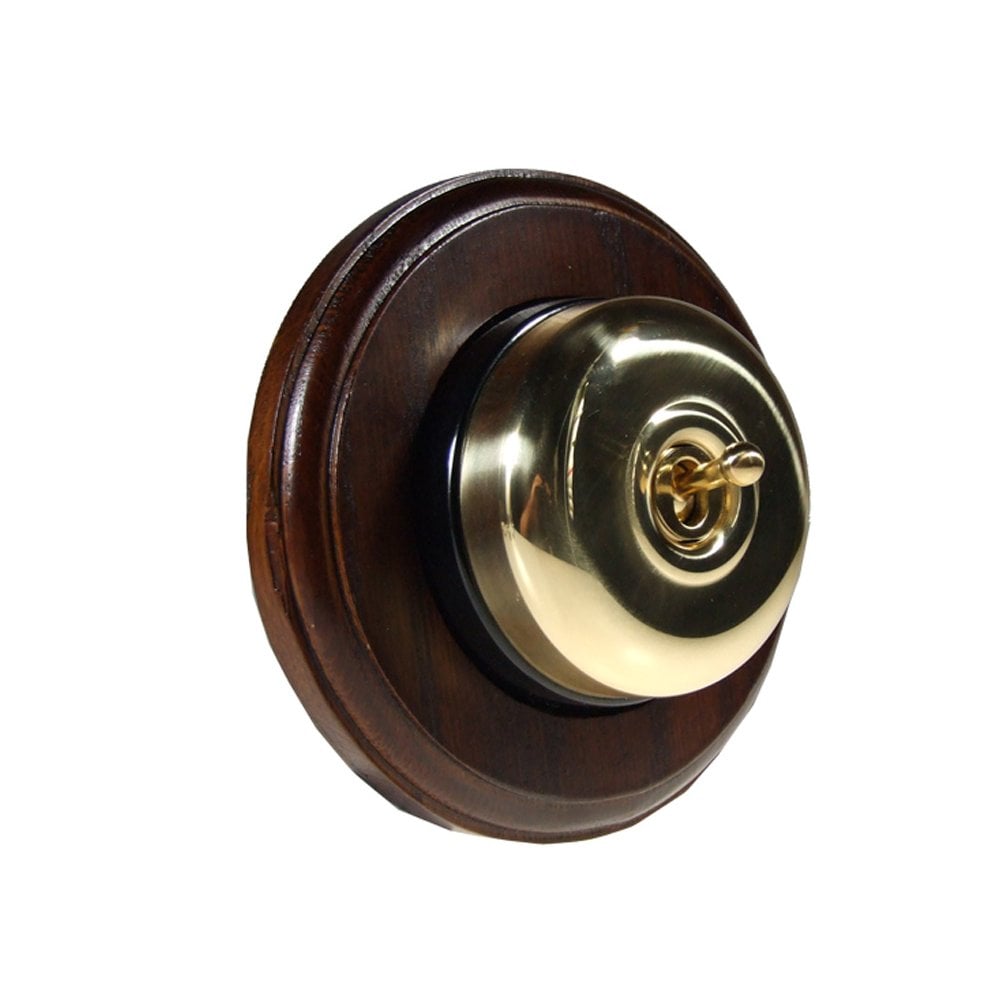 Switch to Wood's Dolly Light Switch Smooth Dome - 1 Gang Round Backplate Polished Brass in Dark Oak