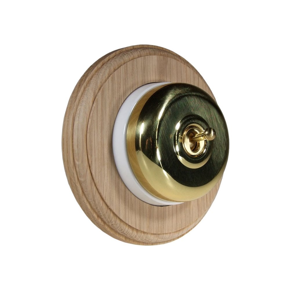 Switch to Wood's Dolly Light Switch Smooth Dome - 1 Gang Round Backplate Polished Brass in Unfinished Oak