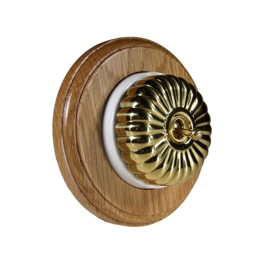 Switch to Wood's Dolly Light Switch Fluted Dome - 1 Gang Round Backplate Polished Brass in Light Oak