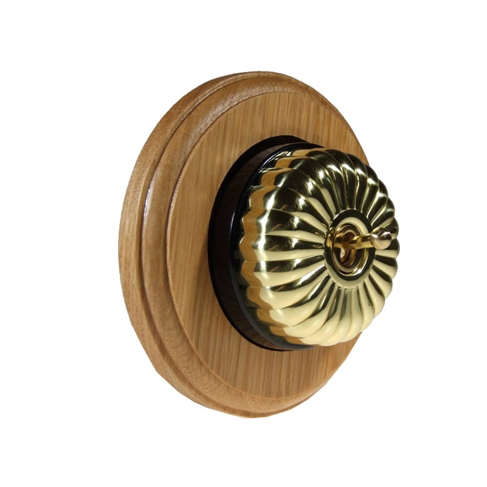 Switch to Wood's Dolly Light Switch Fluted Dome - 1 Gang Round Backplate Polished Brass in Light Oak