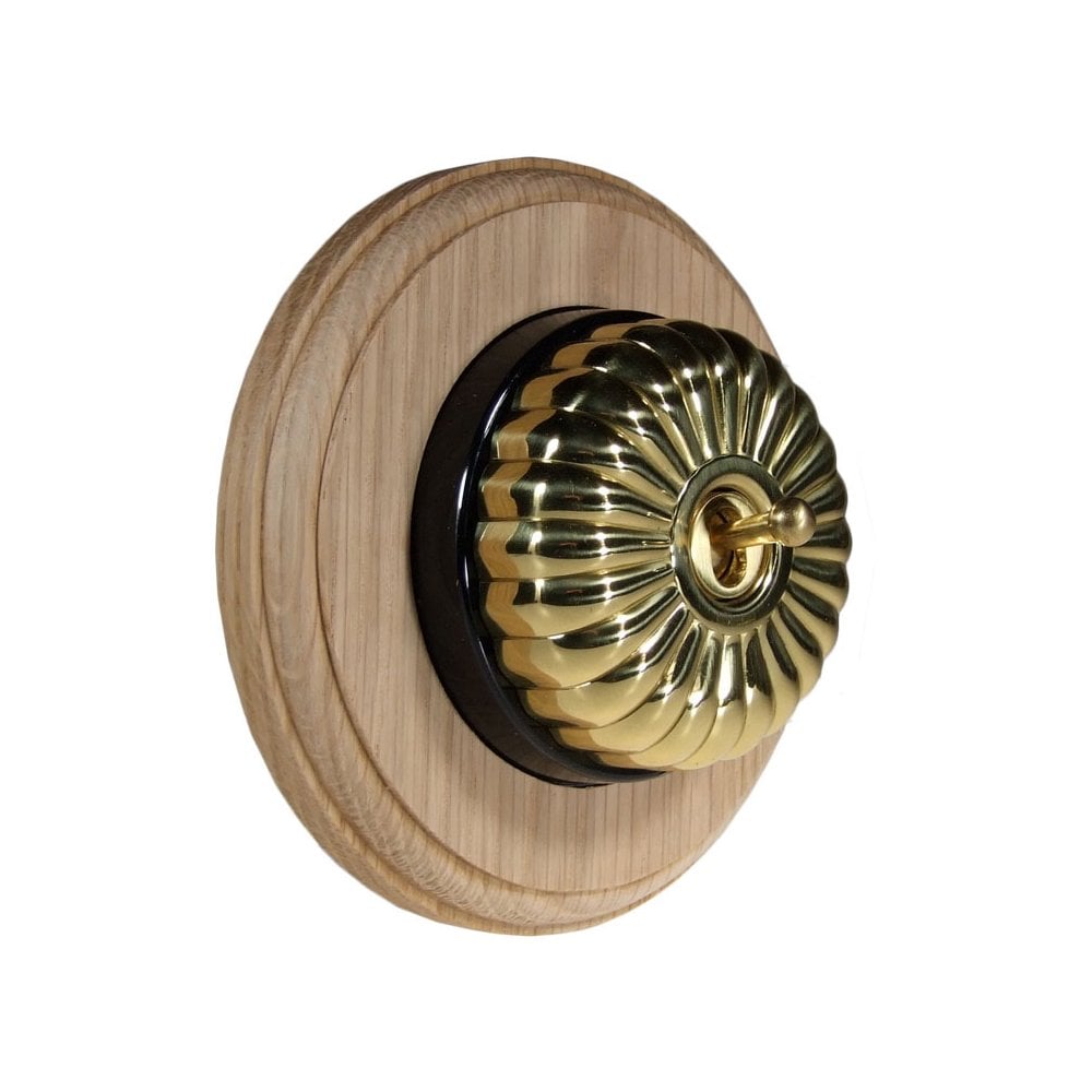 Switch to Wood's Dolly Light Switch Fluted Dome - 1 Gang Round Backplate Polished Brass in Unfinished Oak