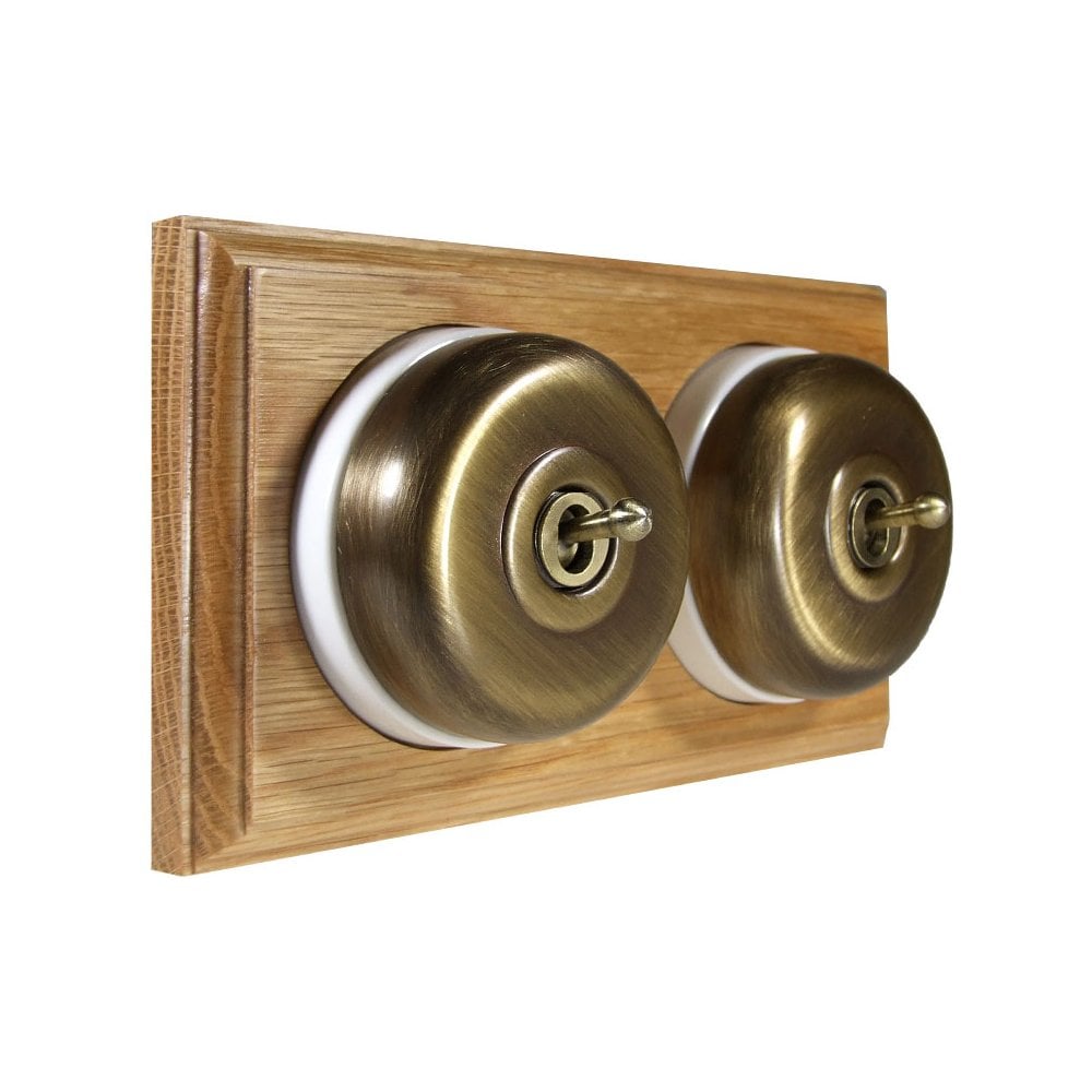Switch to Wood's Dolly Light Switch Smooth Dome - 2 Gang Horizontal Antique Brass in Light Oak