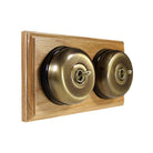 Switch to Wood's Dolly Light Switch Smooth Dome - 2 Gang Horizontal Antique Brass in Light Oak