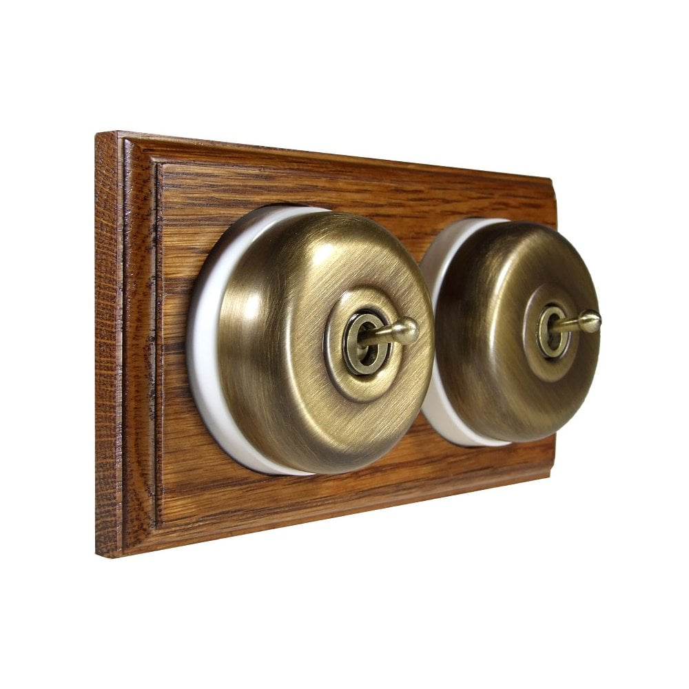 Switch to Wood's Dolly Light Switch Smooth Dome - 2 Gang Horizontal Antique Brass in Medium Oak 