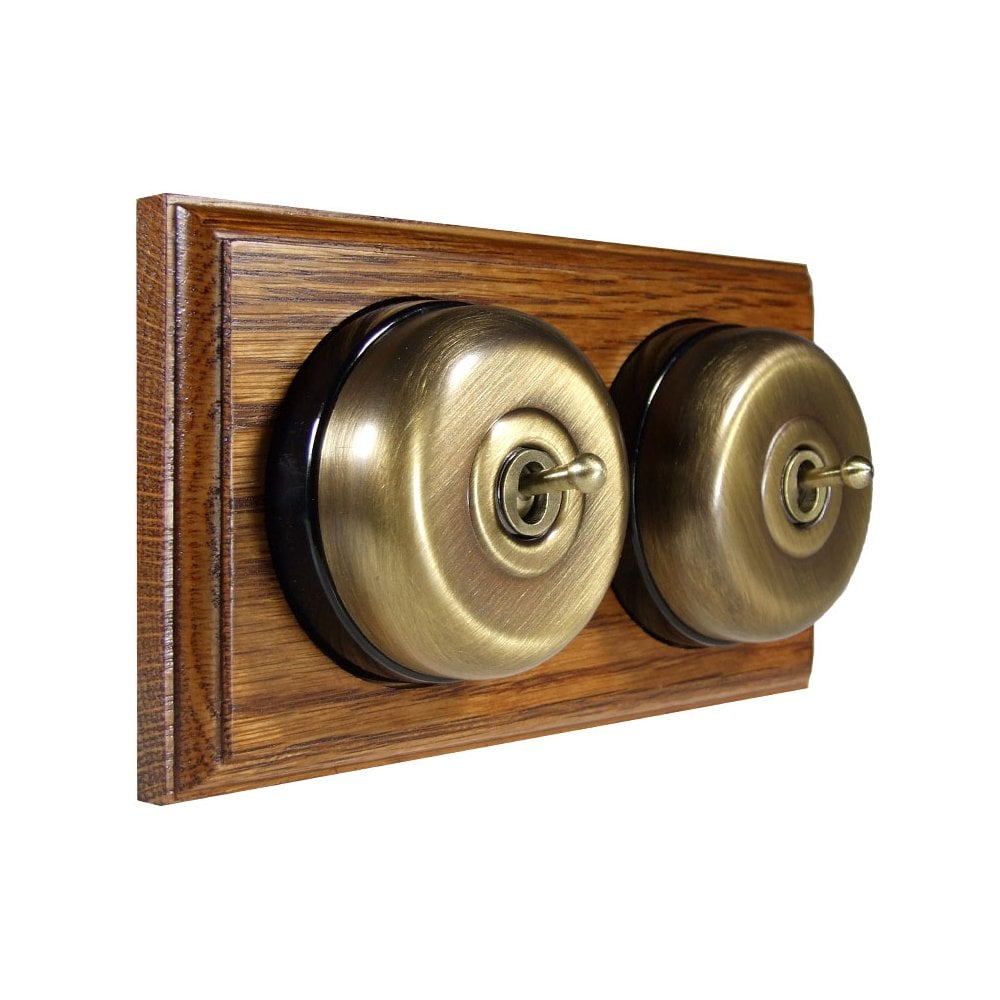 Switch to Wood's Dolly Light Switch Smooth Dome - 2 Gang Horizontal Antique Brass in Medium Oak 