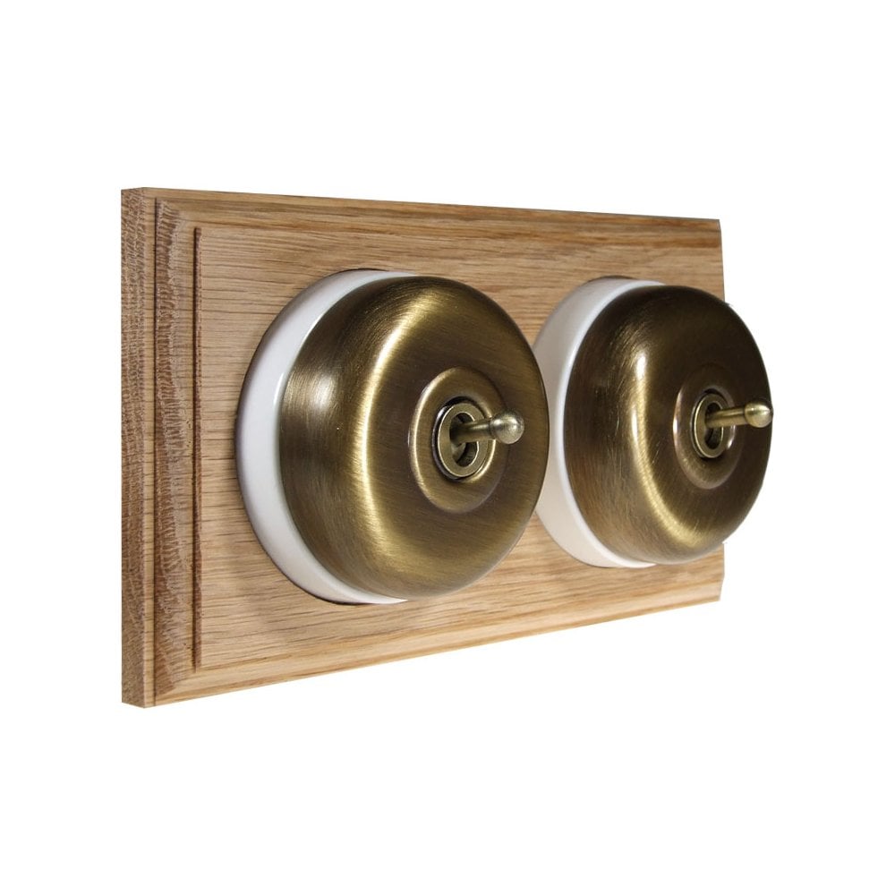 Switch to Wood's Dolly Light Switch Smooth Dome - 2 Gang Horizontal Antique Brass in Unfinished Oak