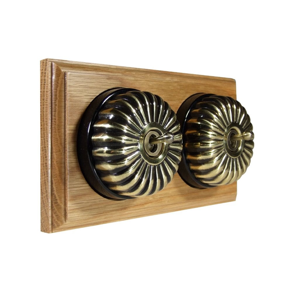 Switch to Wood's Dolly Light Switch Fluted Dome - 2 Gang Horizontal Antique Brass in Light Oak