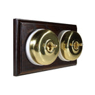 Switch to Wood's Dolly Light Switch Smooth Dome - 2 Gang Horizontal Polished Brass in Dark Oak
