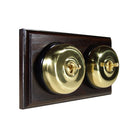 Switch to Wood's Dolly Light Switch Smooth Dome - 2 Gang Horizontal Polished Brass in Dark Oak