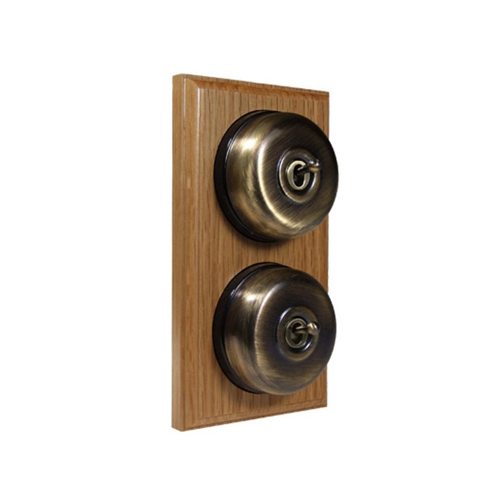 Switch to Wood's Dolly Light Switch Smooth Dome - 2 Gang Vertical Antique Brass in Light Oak
