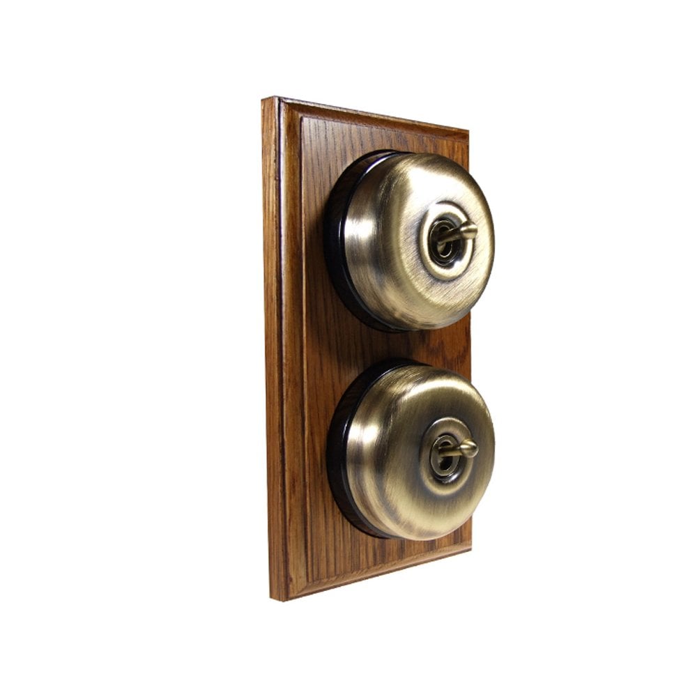 Switch to Wood's Dolly Light Switch Smooth Dome - 2 Gang Vertical Antique Brass in Medium Oak 