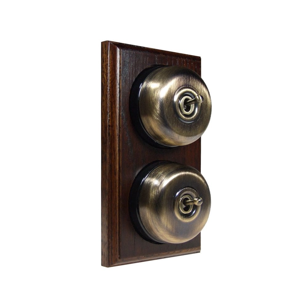 Switch to Wood's Dolly Light Switch Smooth Dome - 2 Gang Vertical Antique Brass in Dark Oak