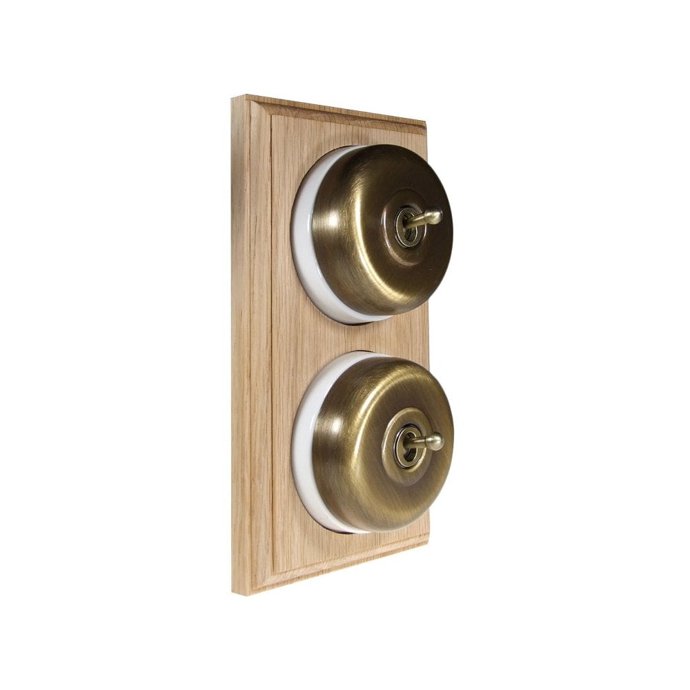 Switch to Wood's Dolly Light Switch Smooth Dome - 2 Gang Vertical Antique Brass in Unfinished Oak