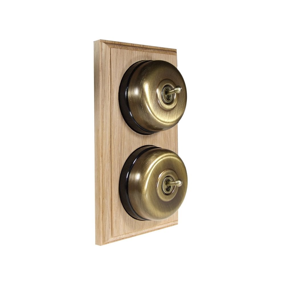 Switch to Wood's Dolly Light Switch Smooth Dome - 2 Gang Vertical Antique Brass in Unfinished Oak