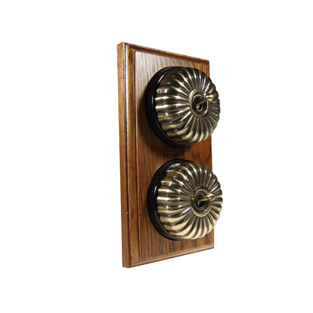 Switch to Wood's Dolly Light Switch Fluted Dome - 2 Gang Vertical Antique Brass in Medium Oak 
