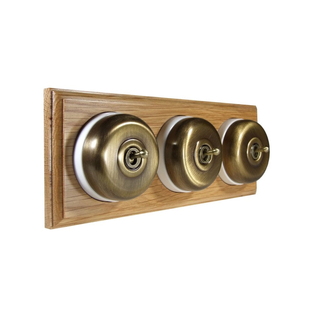 Switch to Wood's Dolly Light Switch Smooth Dome - 3 Gang Horizontal Antique Brass in Light Oak