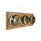 Switch to Wood's Dolly Light Switch Smooth Dome - 3 Gang Horizontal Antique Brass in Light Oak