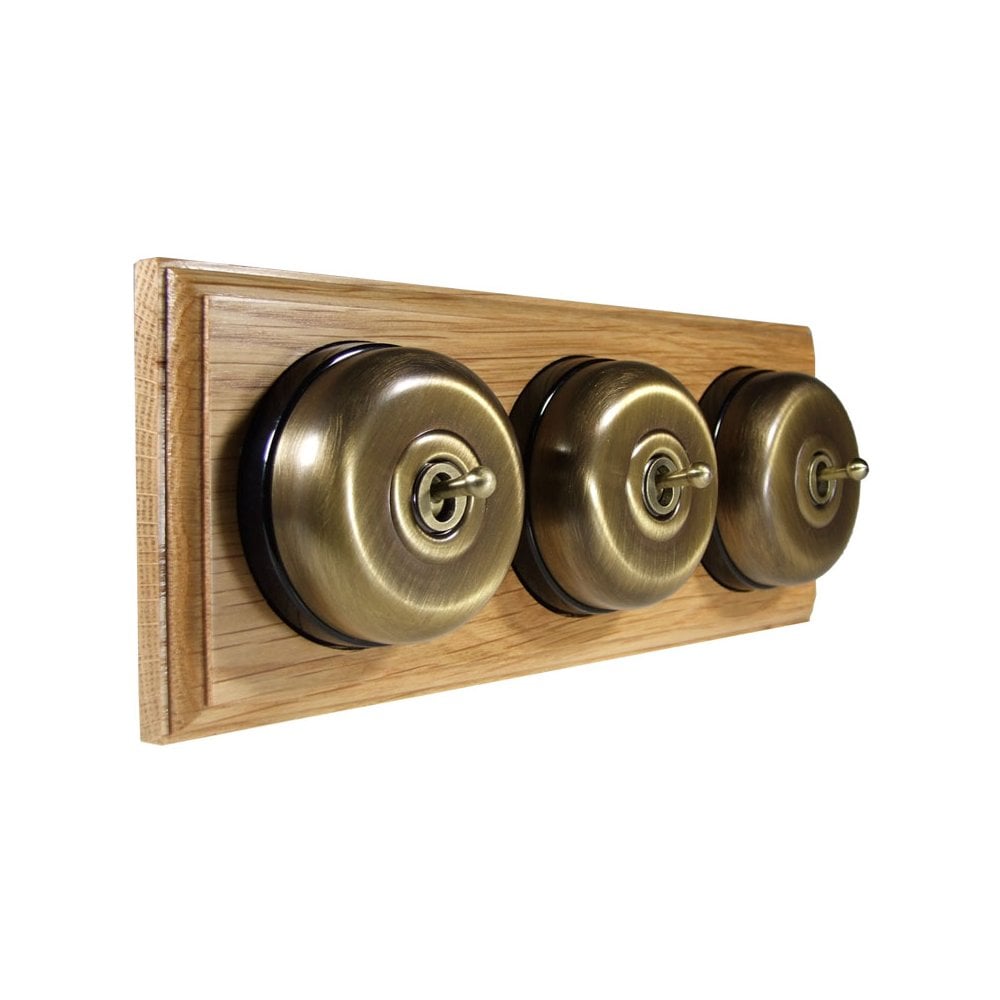 Switch to Wood's Dolly Light Switch Smooth Dome - 3 Gang Horizontal Antique Brass in Light Oak