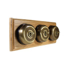 Switch to Wood's Dolly Light Switch Smooth Dome - 3 Gang Horizontal Antique Brass in Light Oak