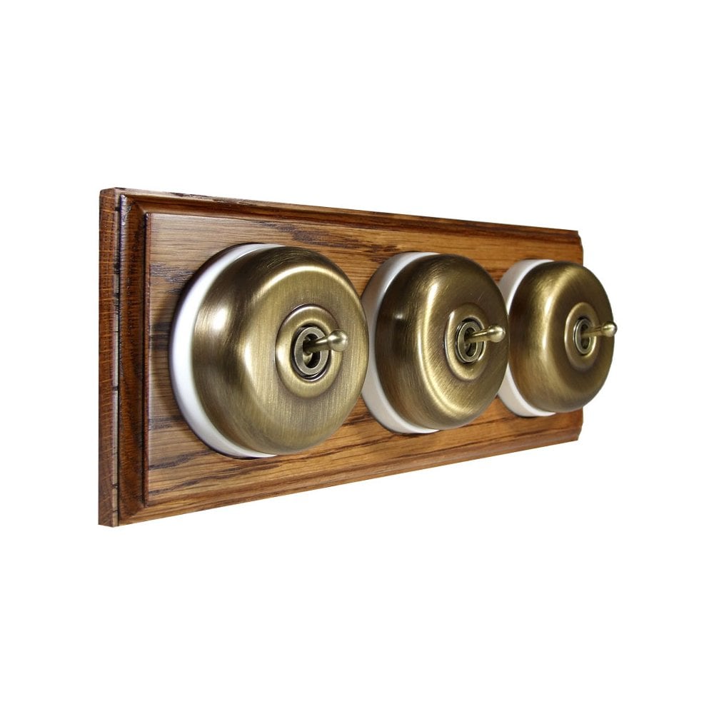 Switch to Wood's Dolly Light Switch Smooth Dome - 3 Gang Horizontal Antique Brass in Medium Oak 