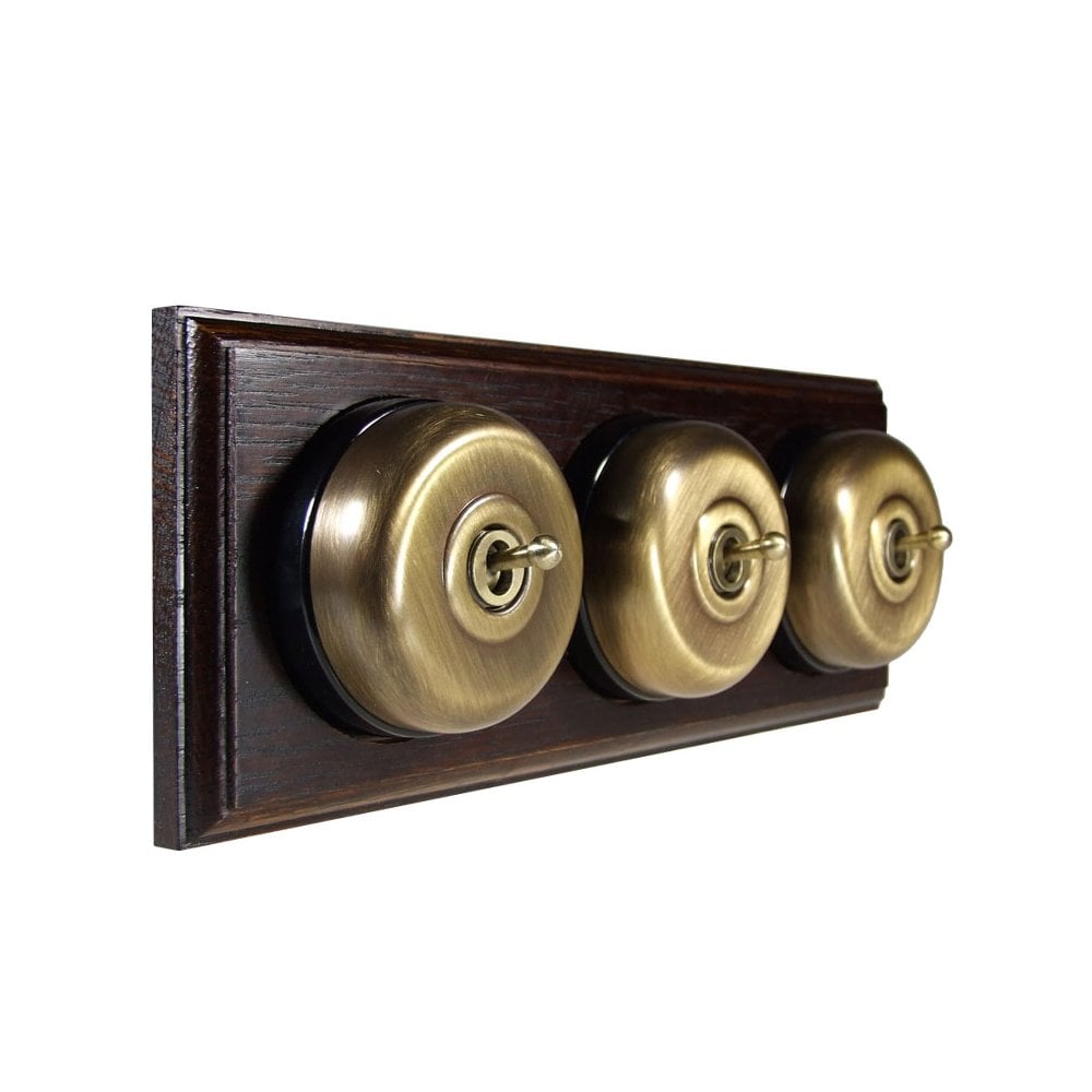 Switch to Wood's Dolly Light Switch Smooth Dome - 3 Gang Horizontal Antique Brass in Dark Oak