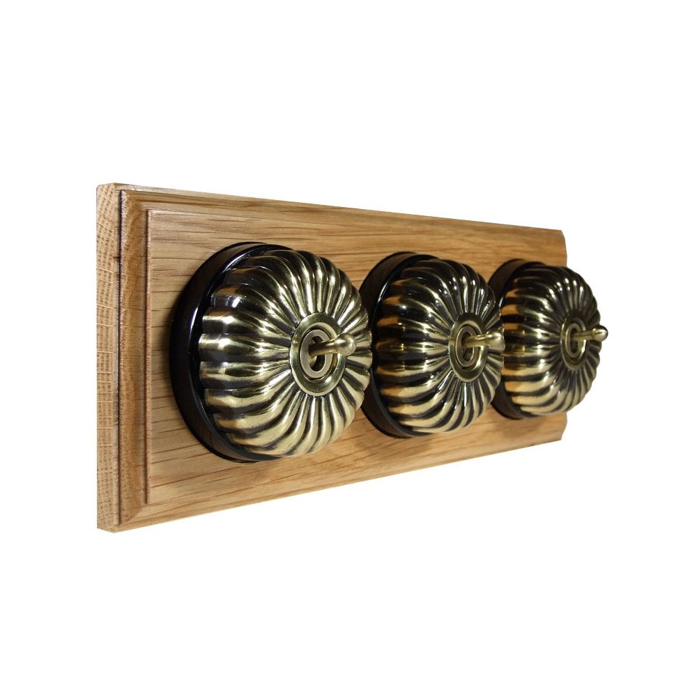 Switch to Wood's Dolly Light Switch Fluted Dome - 3 Gang Horizontal Antique Brass in Light Oak