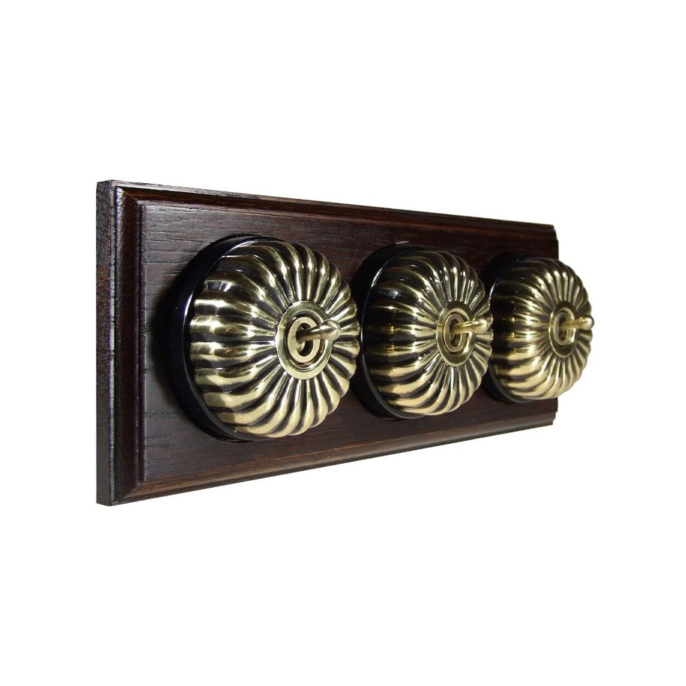 Switch to Wood's Dolly Light Switch Fluted Dome - 3 Gang Horizontal Antique Brass in Dark Oak