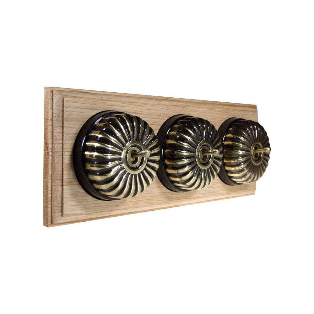Switch to Wood's Dolly Light Switch Fluted Dome - 3 Gang Horizontal Antique Brass in Unfinished Oak